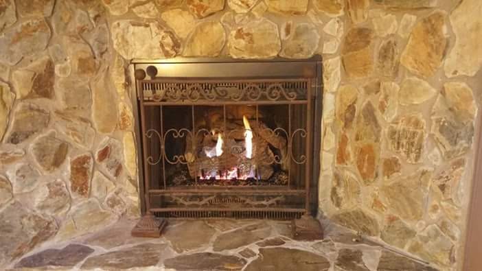Installed gas fireplace with log set