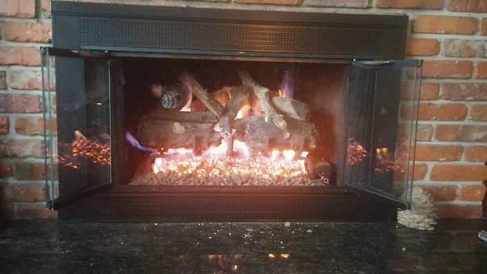 Gas fireplace burning in a brick fireplace
